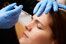 Woman's face at Botox injection process