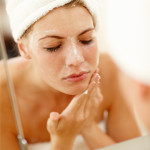 woman-washing-face-with-scrub