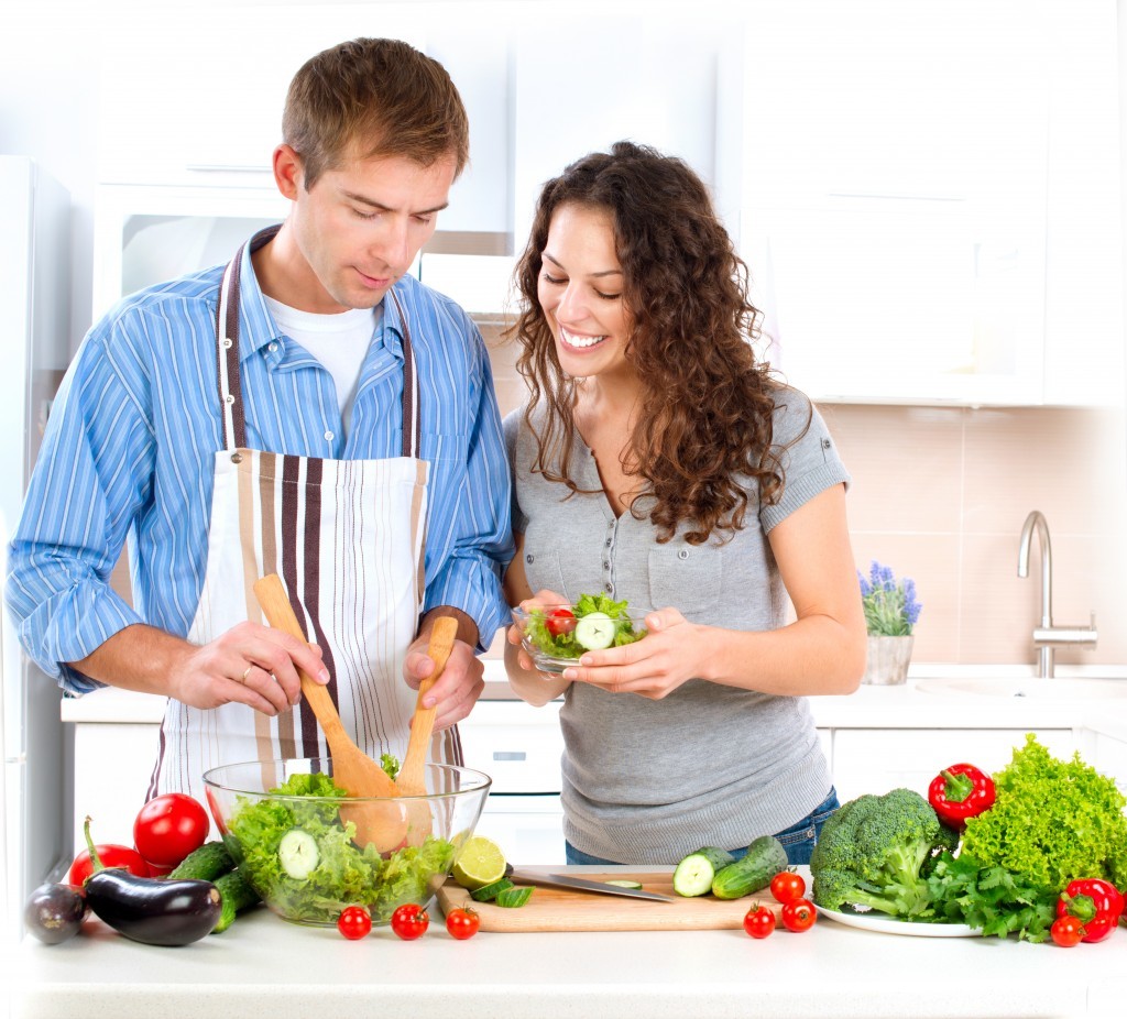 couple making salad at kitchen