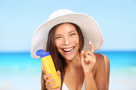 Happy woman with sunscreen photo