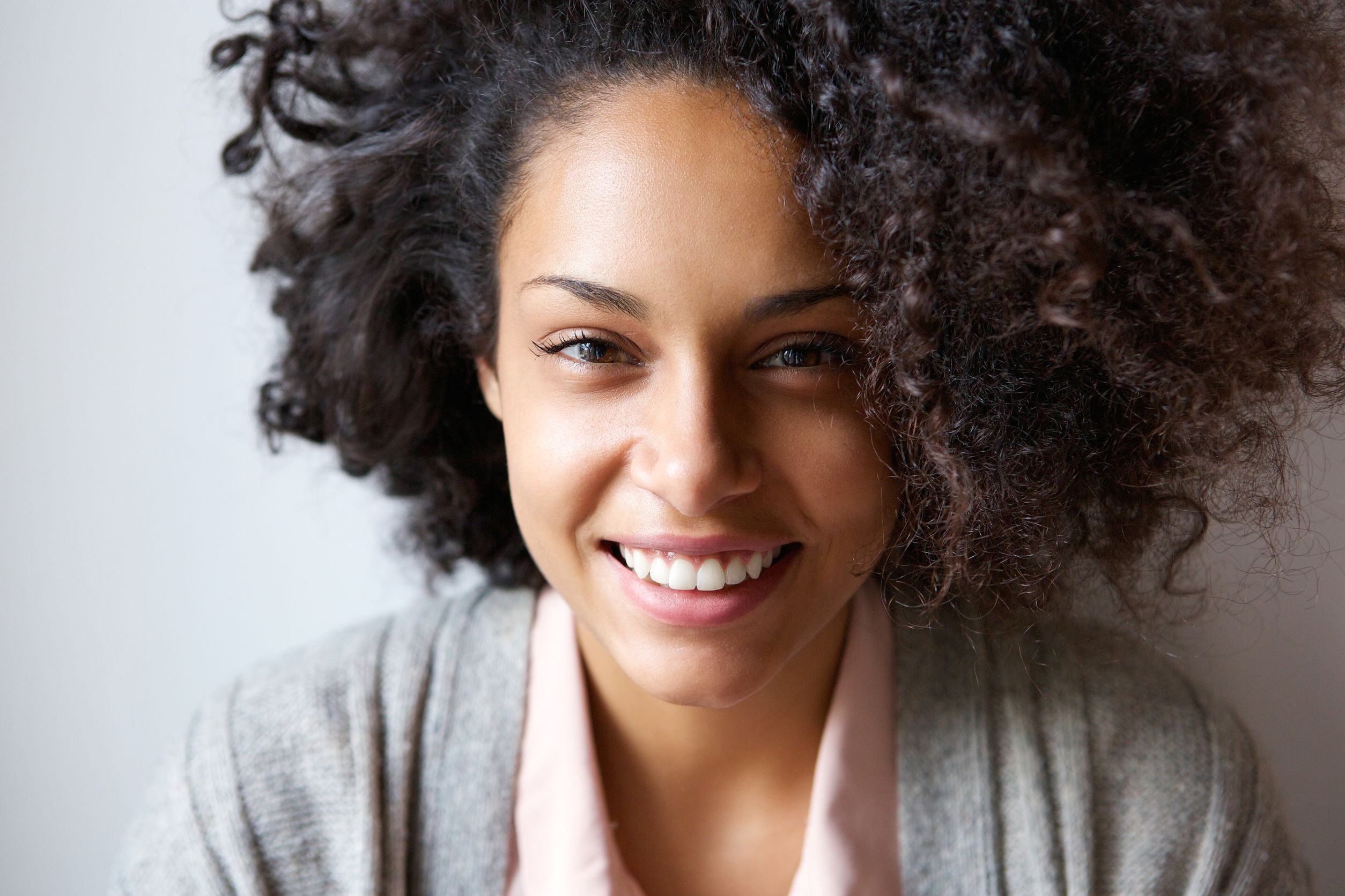 Smiling woman - The Best Skin Care Treatments for Darker Skin
